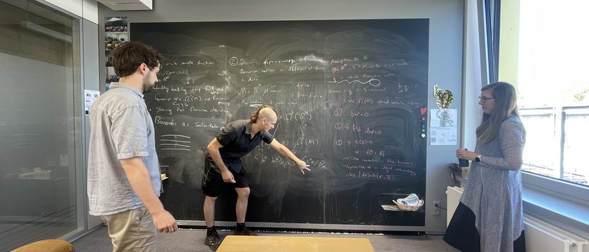 Max Planck Mathematicians at the board under the helpful eye of Heather Harrington Max Planck Mathematicians at the board under the helpful eye of Heather Harrington